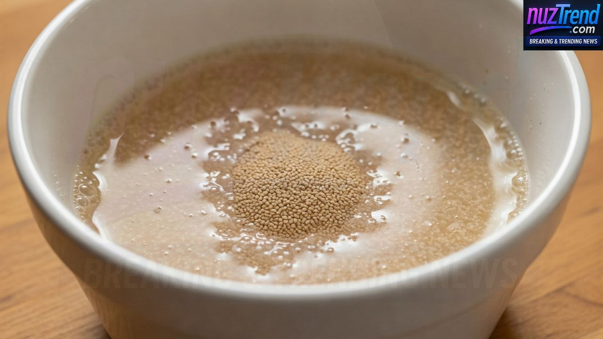 Mixing yeast in warm water in a small bowl
