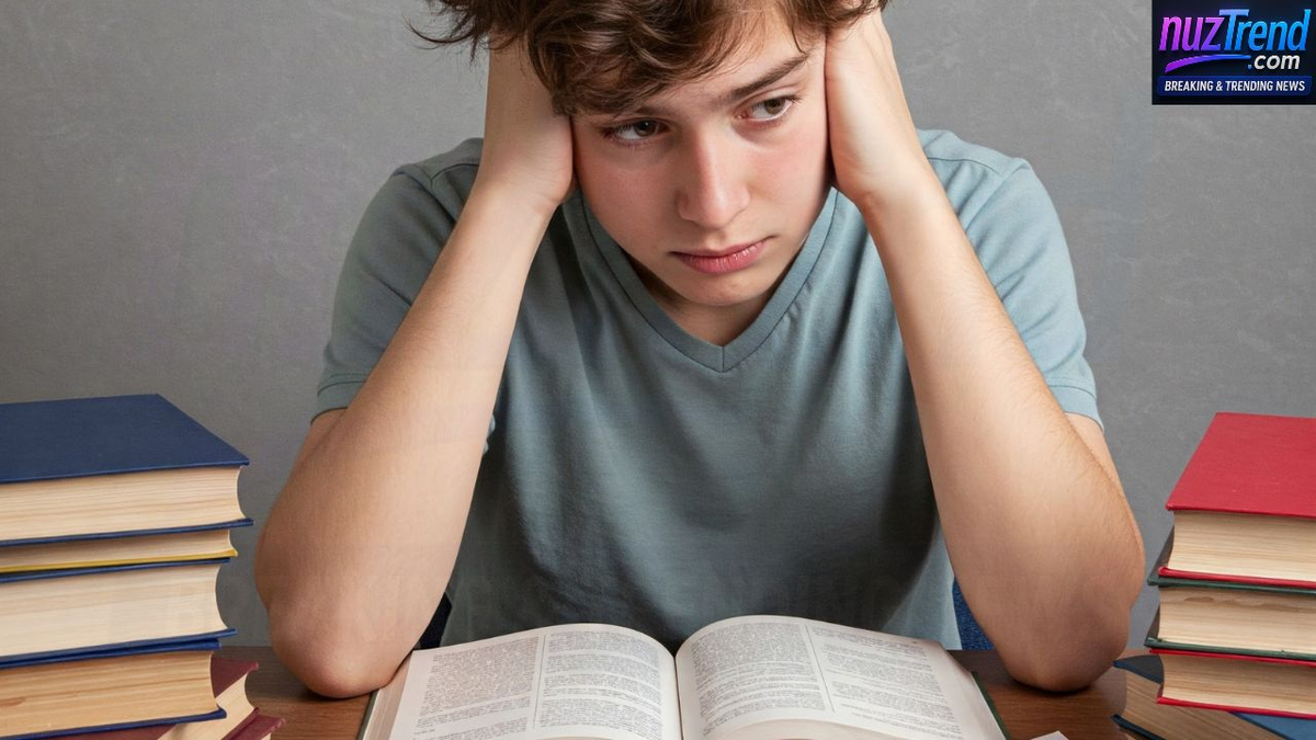 A young boy sitting at a study table looking distracted and unable to concentrate.