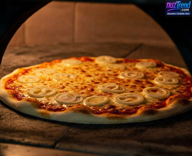 Pizza baking in the oven until golden