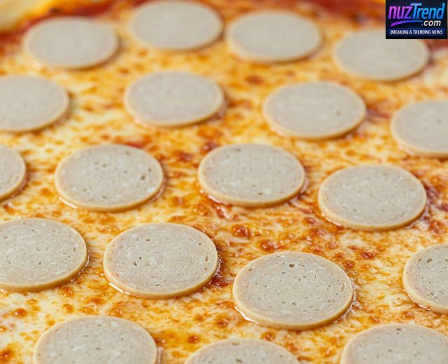 Veg pepperoni slices placed over cheese