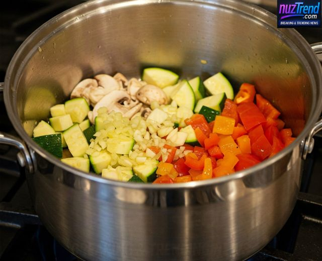 Sautéing onions, garlic, mushrooms, and zucchini in olive oil