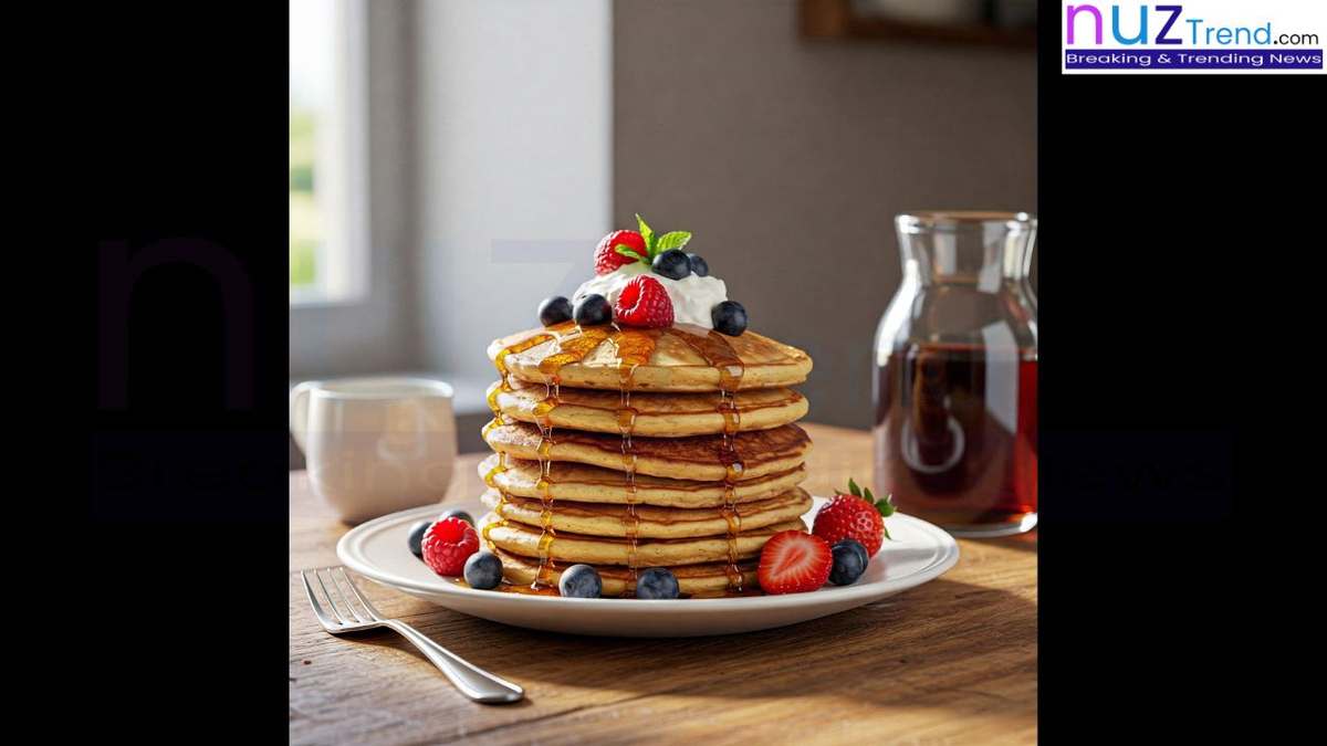 Pancakes served with fruits and maple syrup