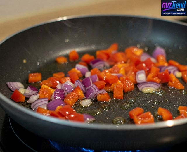 Sautéing bell peppers and onions in a non-stick pan