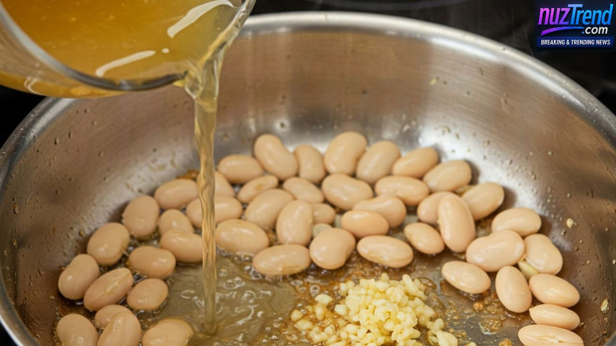 Pouring vegetable broth into skillet